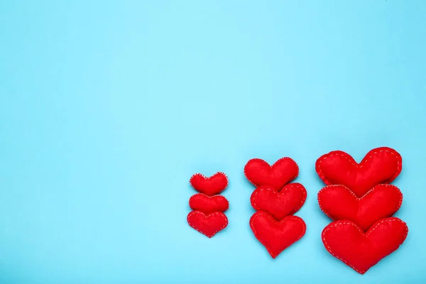 Fabric hearts on blue background — Stock Photo, Image
