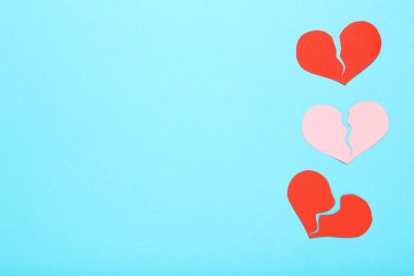 Kırık kağıt kalpler mavi arka planda