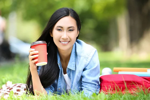 Hermosa Mujer Joven Acostada Hierba Con Libros Taza Papel Mochila — Foto de Stock