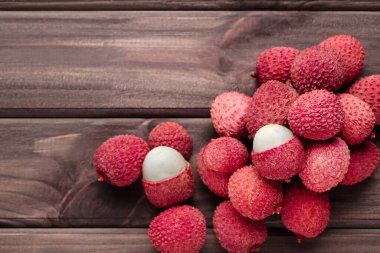 Tasty lychee on wooden table clipart