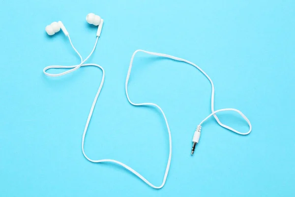 White earphones on blue background