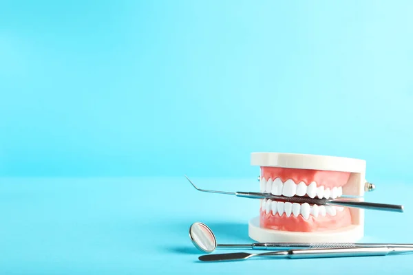 Modelo Dientes Con Instrumentos Dentales Sobre Fondo Azul —  Fotos de Stock