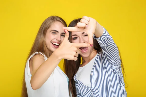 Young Happy Girlfriends Making Frame Fingers Yellow Background — Stock Photo, Image