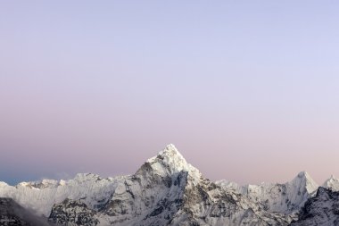 Early morning lights over the mountain Ama Dablam summit in Himalayas, Nepal. clipart