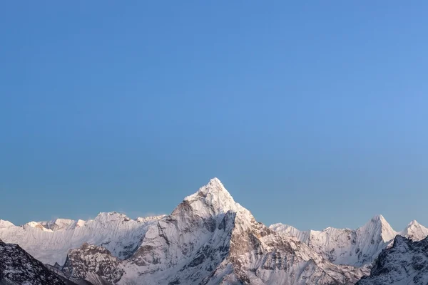 Early morning lights over the mountain Ama Dablam summit in Himalayas, Nepal.