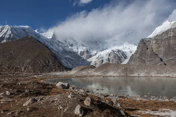 Lago morrena gris y pico nevado cubierto de nubes en Himalaya, Nepal . — Foto de Stock
