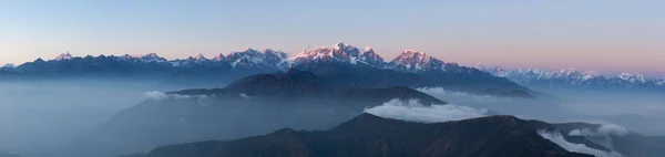 Panoramic mountain landscape with amazing clouds floating between hills on the sunrise. — Stock Photo, Image