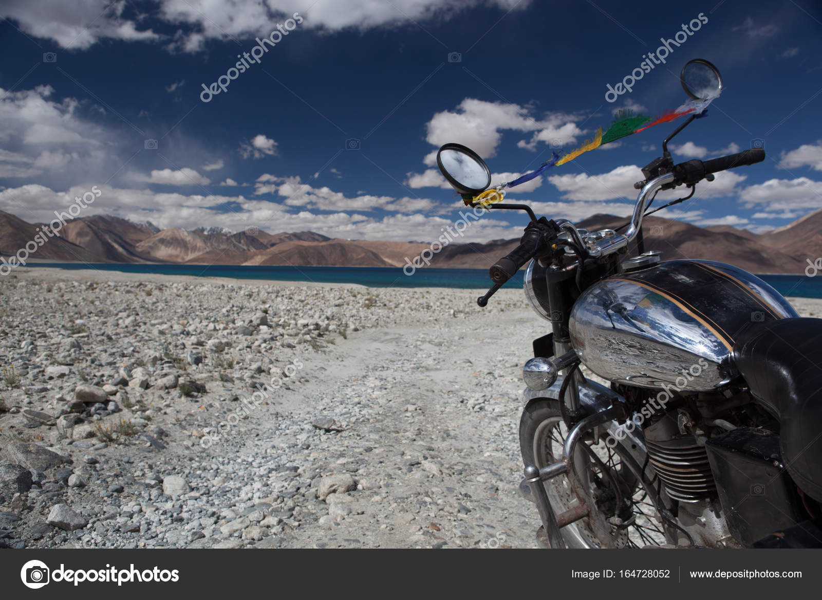 Vintage motorcycle on background of beautiful mountain lake Pangong lake in  Ladakh by vintage Stock Photo by ©gagarych 164728052