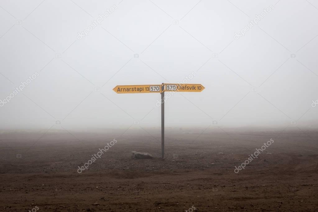 Iceland hiking in Saefellsnes national park Road sign on the rural crossroad  yellow arrows to the