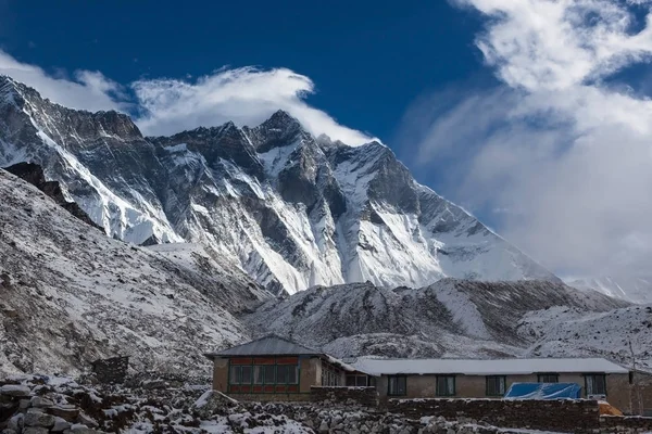 Mountain house in snow under Lhotse mountain vertical wall House in snowy mountains on Everest Base