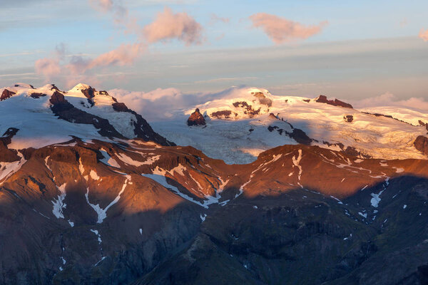 Volcano mountain covered with snow on sunset Eyjafjallajokull mountain in Southern Iceland