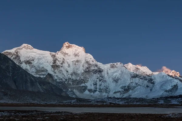 Dusk lights over the mountain Cholatse summit in Himalayas Nepal Highlands scenery of the mountain