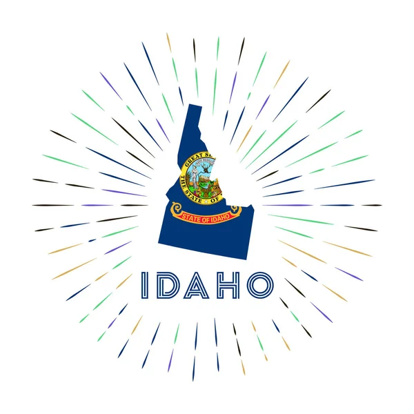 Idaho sunburst badge Il segno di stato degli Stati Uniti con mappa dell'Idaho con bandiera di stato Raggi colorati intorno alla — Vettoriale Stock