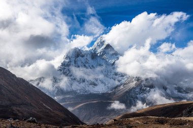 Dramatic mountain view of Ama Dablam summit on the famous Everest Base Camp trek in Himalayas, Nepal. Eminent photo.