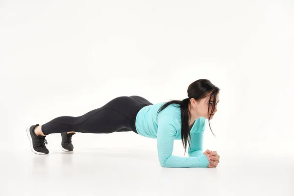 Young athletic woman making yoga and gymnastics stretching exercises isolated on white — Stock Photo, Image