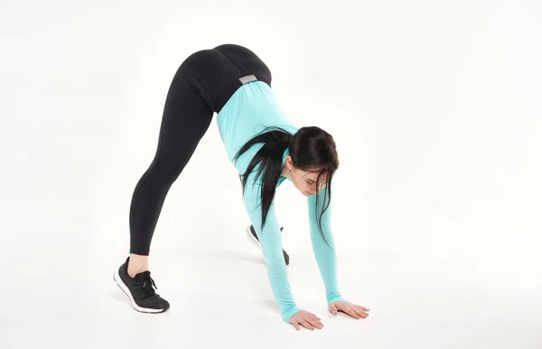 Young athletic woman making yoga and gymnastics stretching exercises isolated on white — Stock Photo, Image