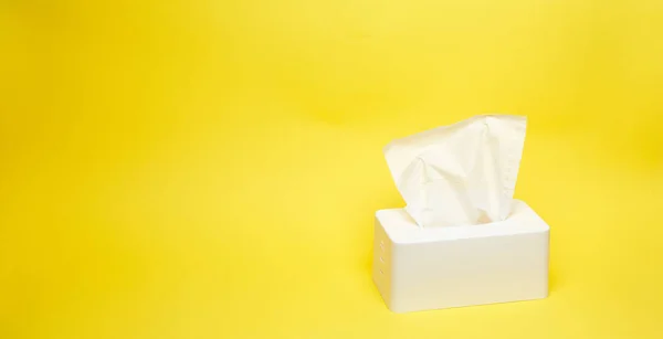 Wide shot of white napkin holder on minimalistic yellow background — Stock Photo, Image