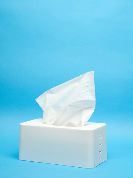 White napkin holder on minimalistic blue background