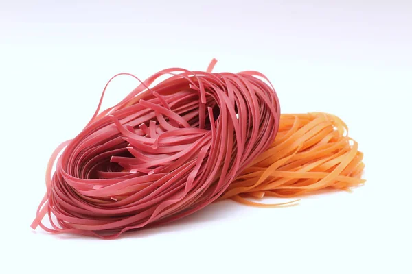 Isolated colored spaghetti nests on a white background. — 스톡 사진