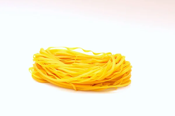 Isolated colored spaghetti nests on a white background. — Stock Photo, Image