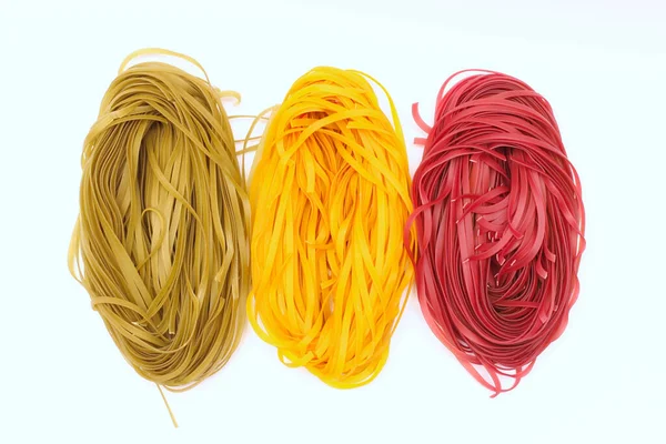 Isolated colored spaghetti nests on a white background. — 스톡 사진