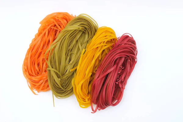 Isolated colored spaghetti nests on a white background. — 스톡 사진