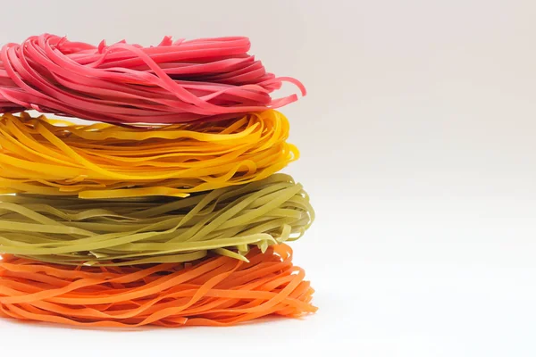 Isolated colored spaghetti nests on a white background. — 스톡 사진