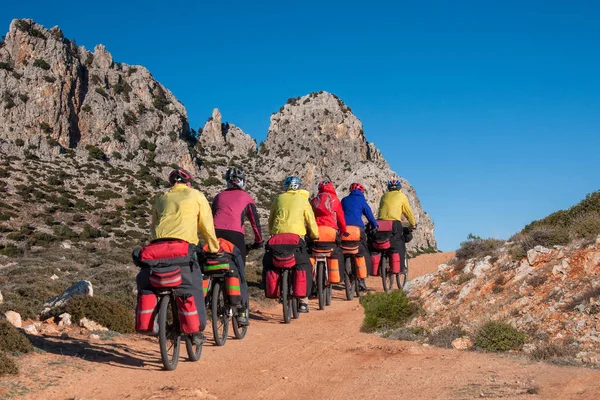 group of biker tourists with large backpacks travel through the mountains in Turkey