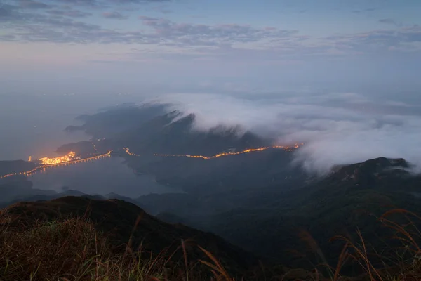 Clouds rolling over hills on the Lantau Island at dawn