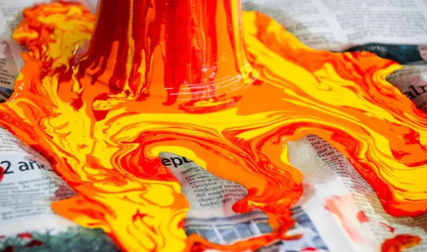 Paint pouring out and spilling on paper — Stock Photo, Image
