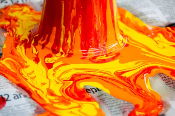 Paint pouring out and spilling on paper — Stock Photo, Image