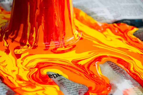 Paint pouring out and spilling on paper — Stock Photo, Image