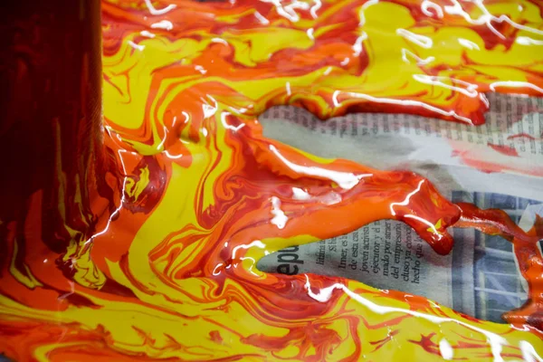 Paint pouring out and spilling on paper