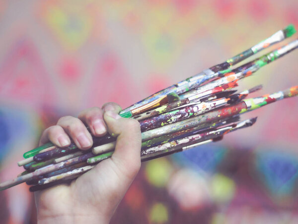Human hand holding art brushes