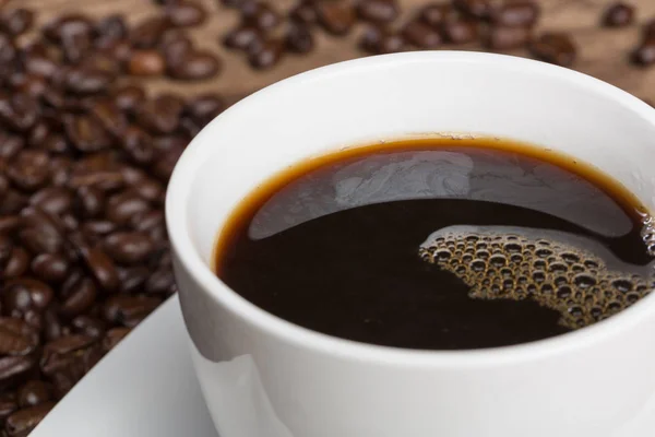 Taza de café y granos de café — Foto de Stock