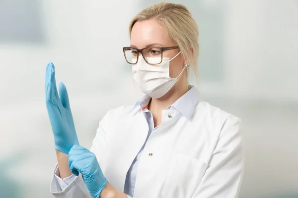 Female Doctor Medical Face Mask Puts Medical Gloves — Stock Photo, Image