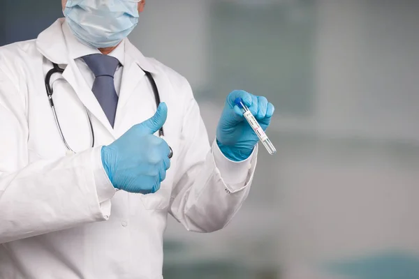 doctor holding a test tube after virus analysis with negative result markers in front of a lab room