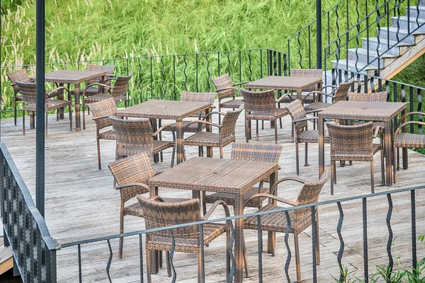 The wood table on natural outdoor of a restaurant with tree and — Stock Photo, Image