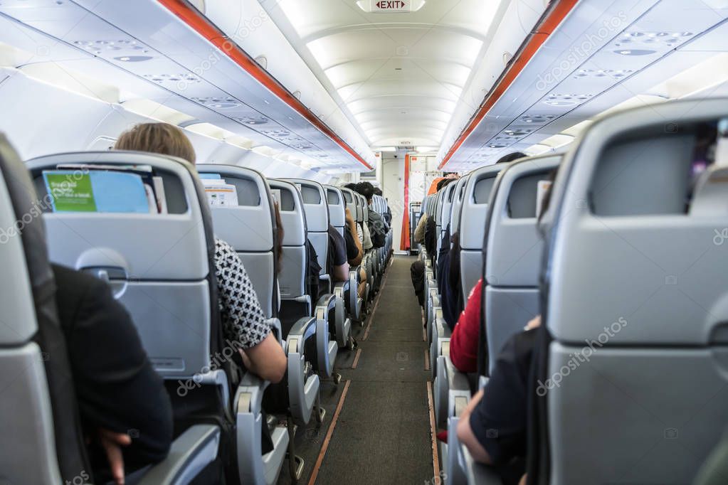 airplane with passengers on seats waiting to take off