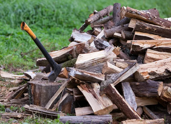 Ax and cuted firewood stack — Stock Photo, Image