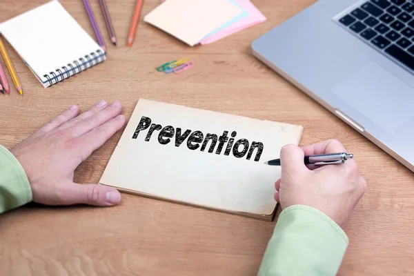 Hand writing Prevention. Office desk with a laptop and stationer — ストック写真