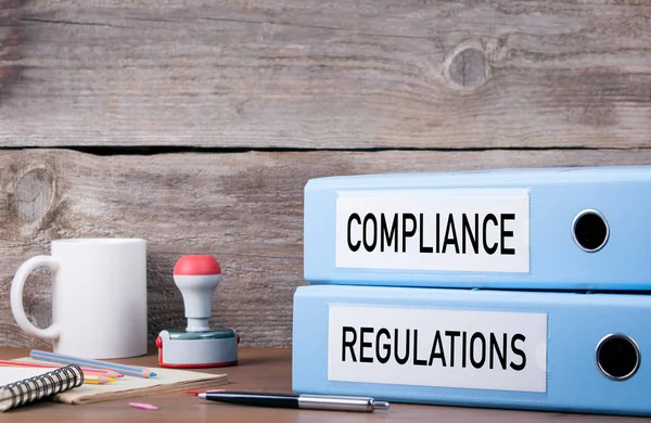 Compliance und Vorschriften. zwei Ordner auf dem Schreibtisch im Büro. b — Stockfoto