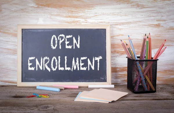 Open Enrollment text on a blackboard. Old wooden table with text — Stock Photo, Image