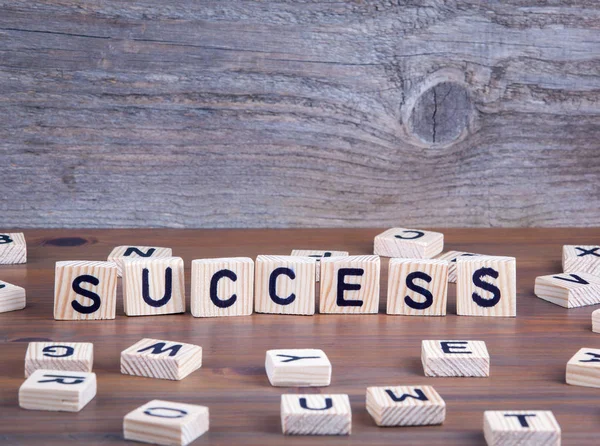 Success from wooden letters on wooden backgroun — Stock Photo, Image