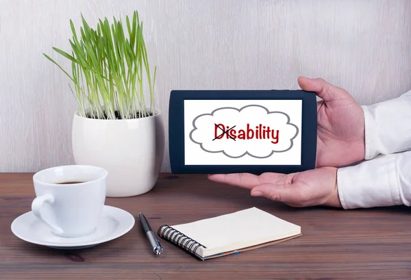 Convertir la palabra Discapacidad en Habilidad. Tableta digital con pantalla aislada en manos masculinas — Foto de Stock