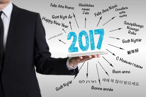 2017 Happy New Year. Young man holding a tablet computer — Stock Photo, Image