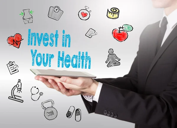Invest in your health concept. Healty lifestyle background. Man holding a tablet computer — Stock Image Invest in your health concept. Healty lifestyle background. Man holding a tablet computer Stock Photo