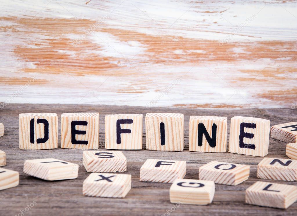 Define from wooden letters on wooden background