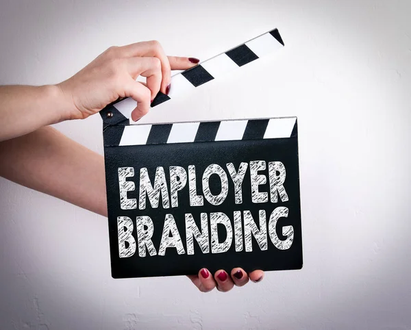 Employer Branding. Female hands holding movie clapper