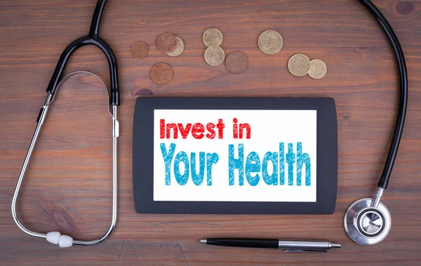Invest in your health. Text on tablet device — Stock Image Invest in your health. Text on tablet device Royalty Free Stock Images